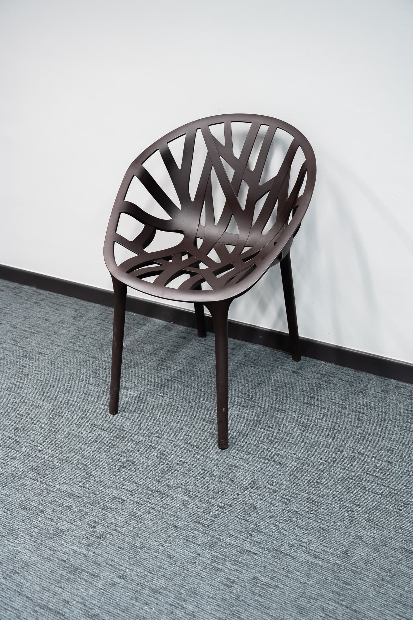 Brown plastic chair vine design
