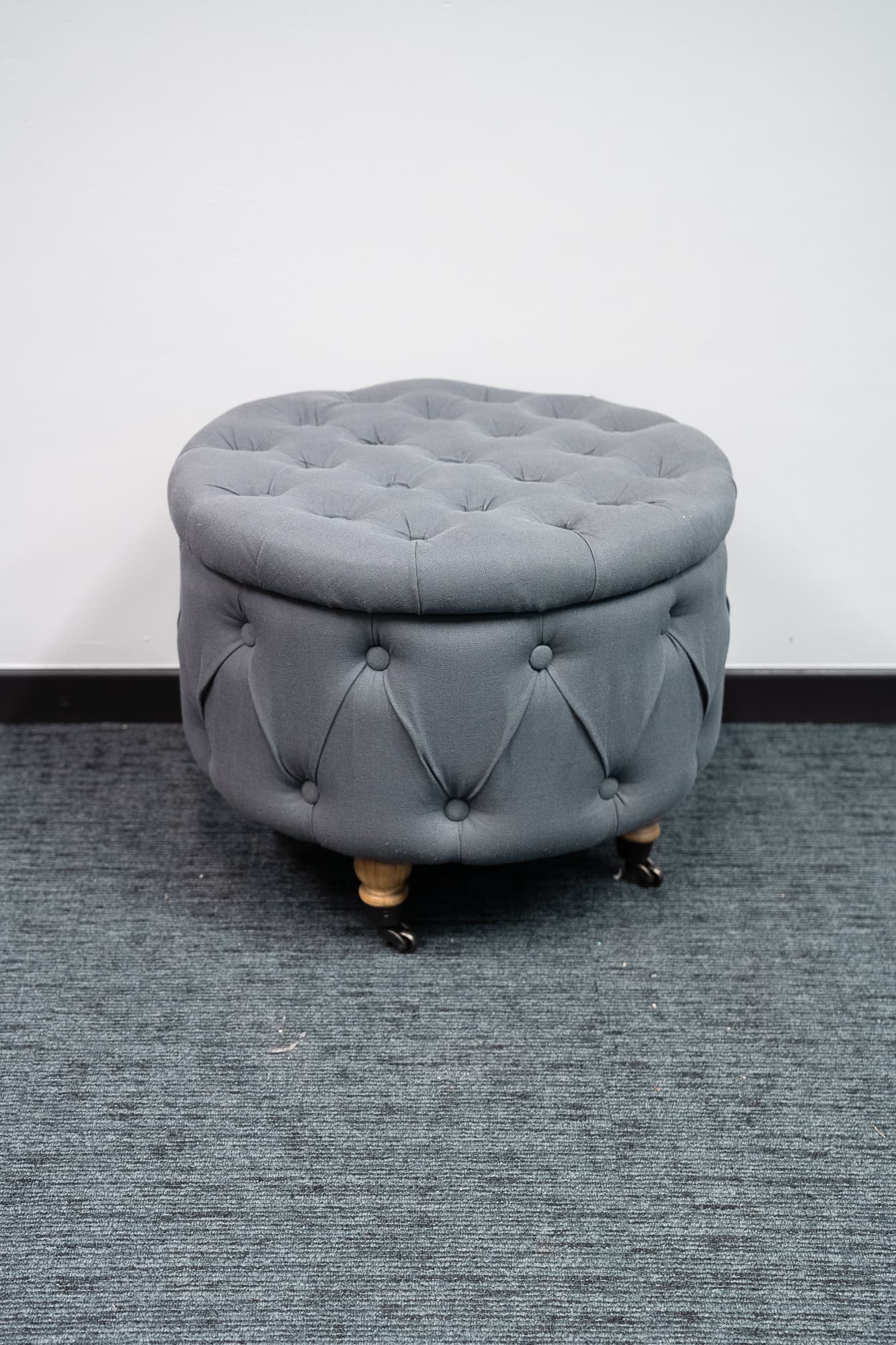 Charming blue-gray velvet pouffe on castors