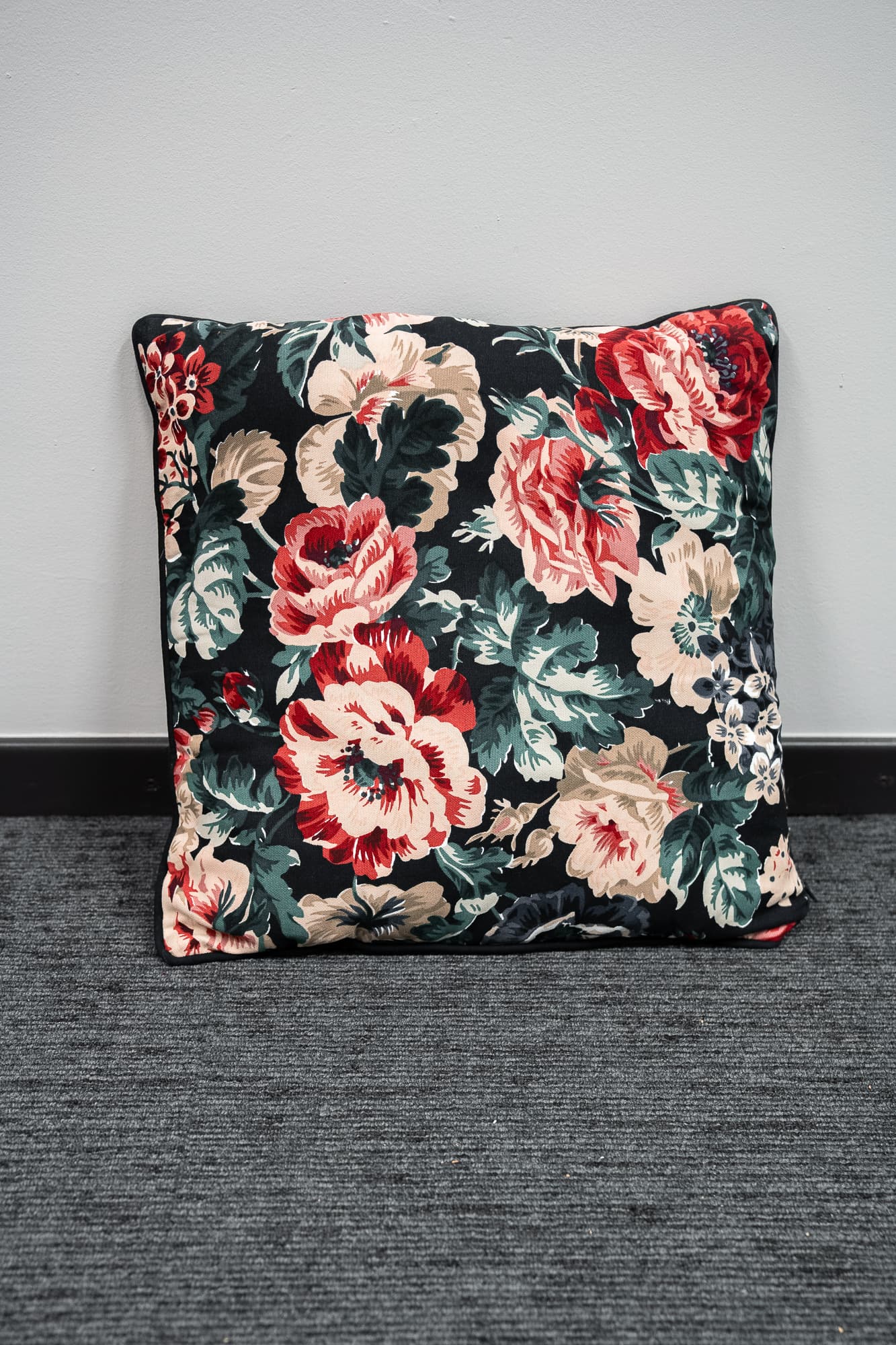 black cushion with floral motifs