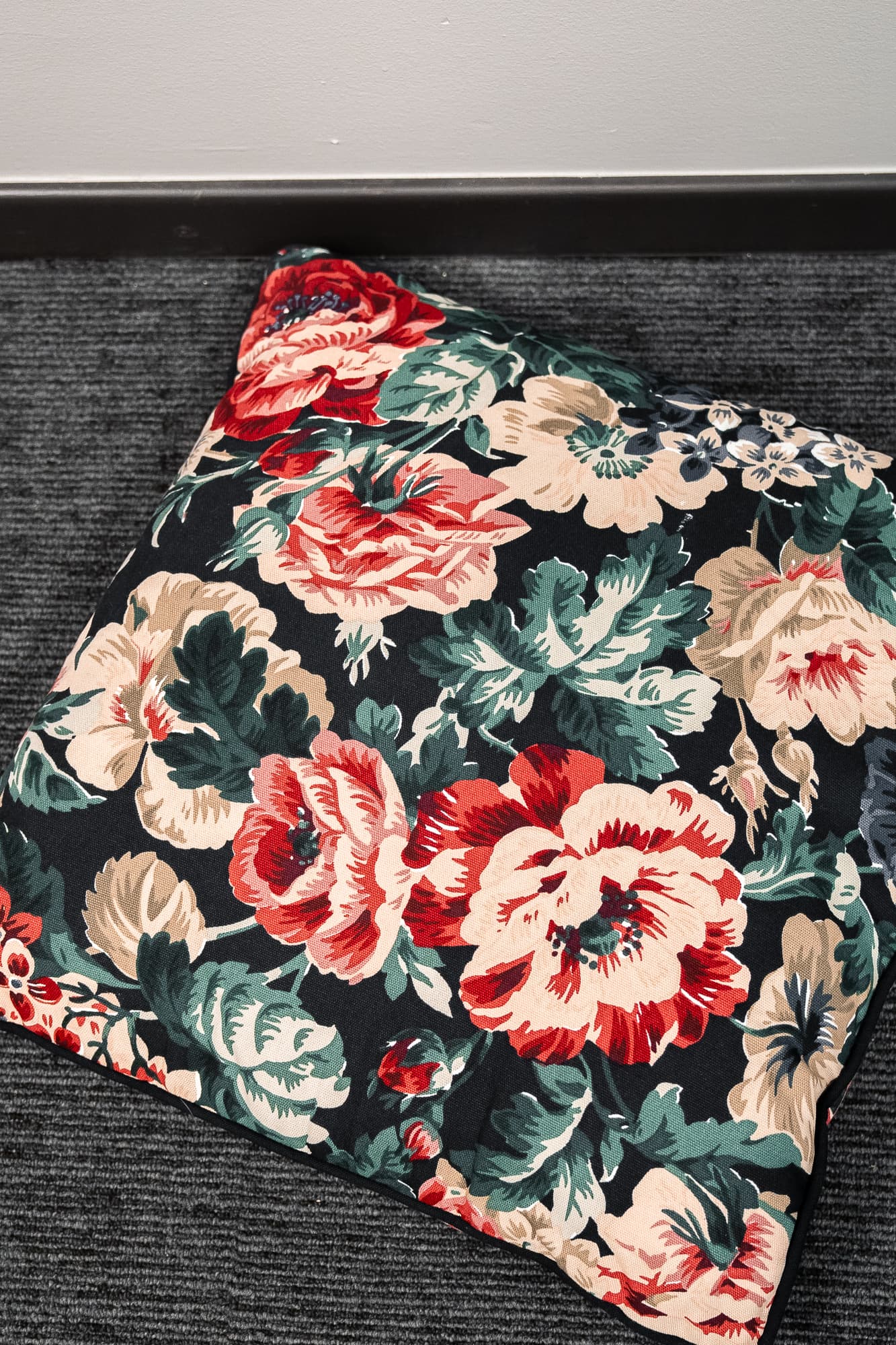black cushion with floral motifs